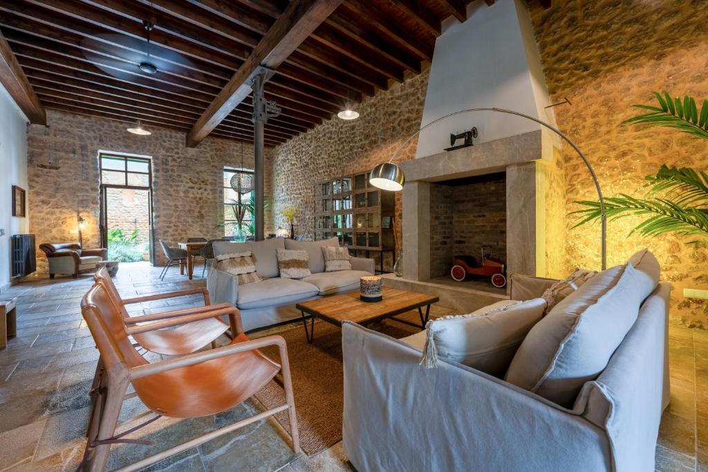 a living room with couches and a fireplace at Loft1882 in Sóller