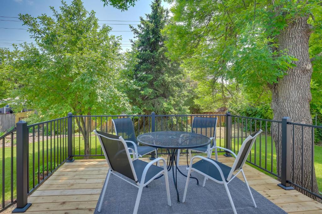 a table and chairs on a deck with a fence at Modern Rapid City Vacation Rental with Deck in Rapid City