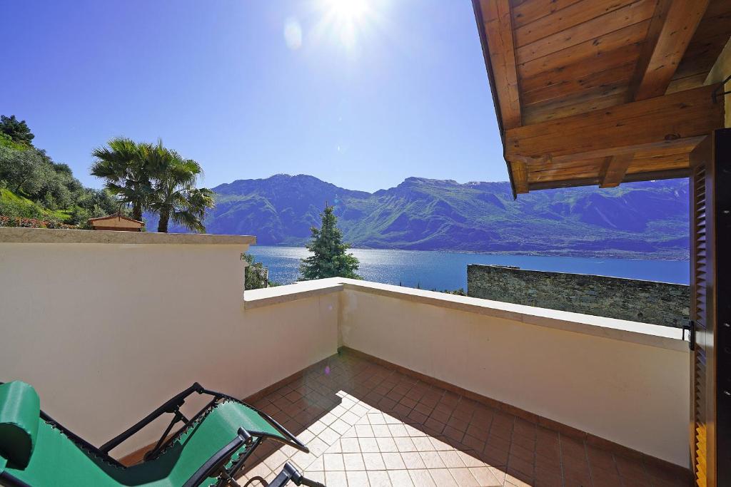 a balcony with chairs and a view of a lake at Villa Fior di Loto in Limone sul Garda