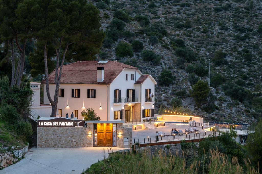 a house with a sign that reads inside the building at LA CASA DEL PANTANO in La Vall de Laguar
