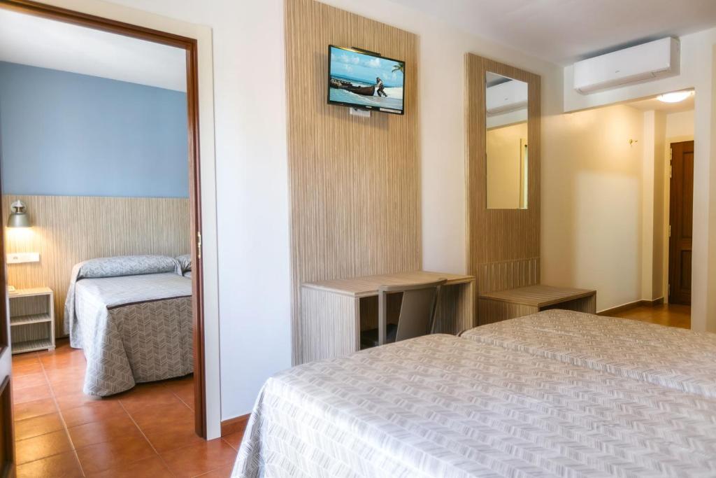 Posteľ alebo postele v izbe v ubytovaní Hotel Galicia