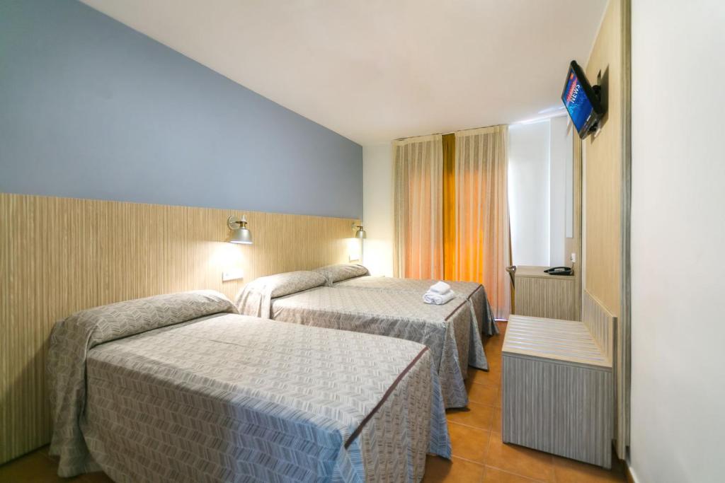 Posteľ alebo postele v izbe v ubytovaní Hotel Galicia