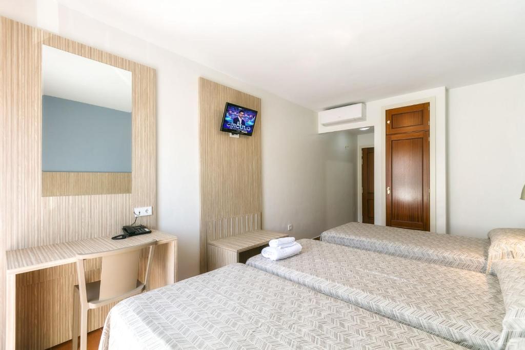 Posteľ alebo postele v izbe v ubytovaní Hotel Galicia