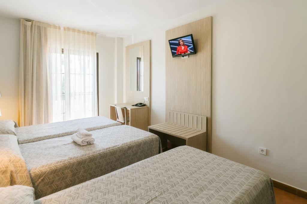 Posteľ alebo postele v izbe v ubytovaní Hotel Galicia