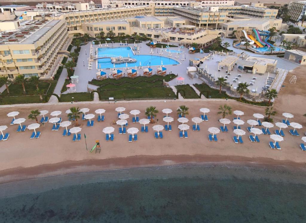 an aerial view of a resort with a pool and umbrellas at Aqua Mondo Abu Soma Resort in Hurghada