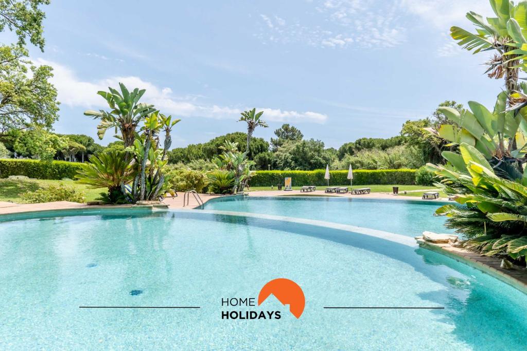 a swimming pool at a resort with a sign that says home holidays at #174 T2 em Zona Tranquila by Home Holidays in Branqueira