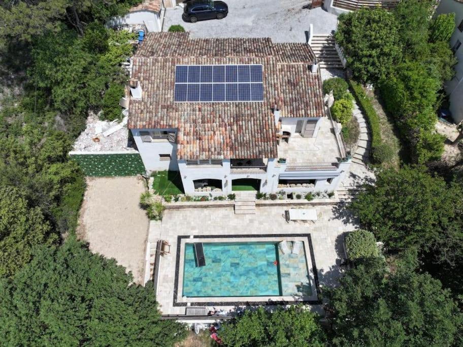 een uitzicht op een huis met een zwembad bij Villa de charme piscine et jacuzzi 190 m2 in Mouans-Sartoux