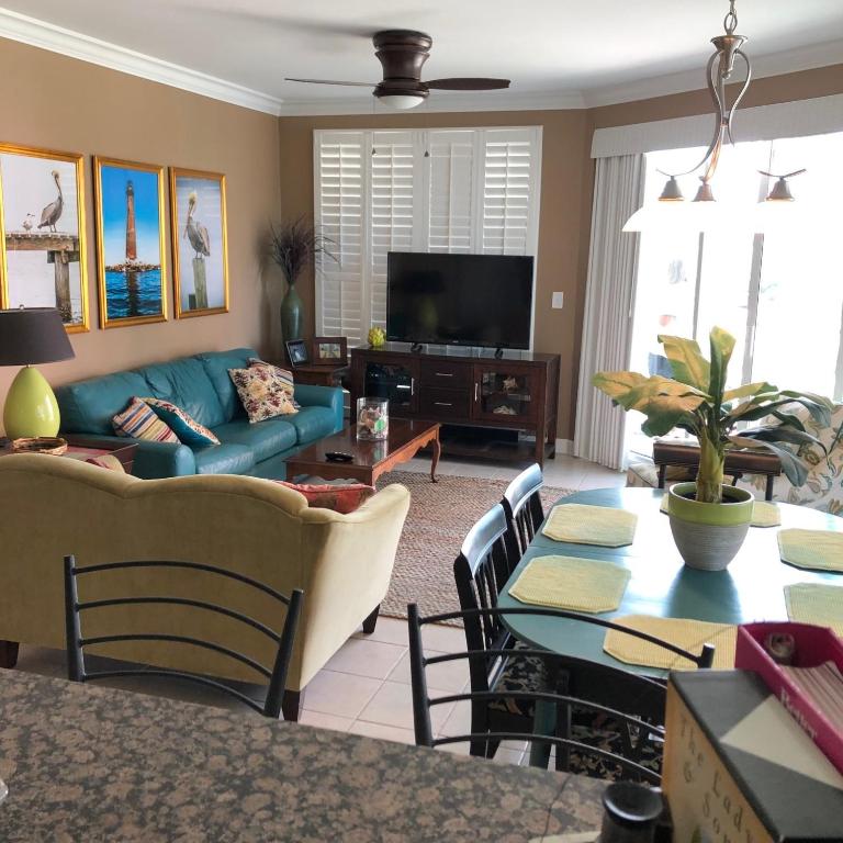 a living room with a couch and a table at Indies 110 in Gulf Shores