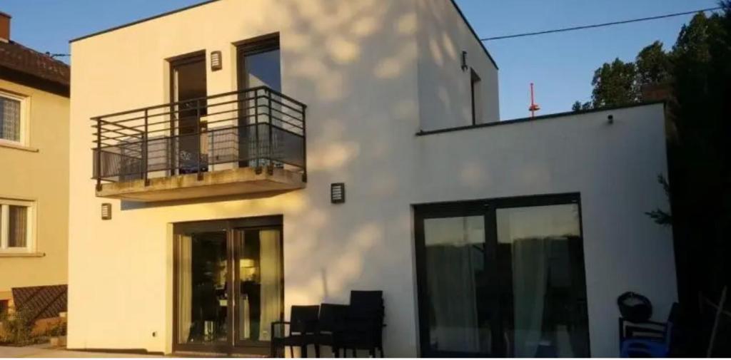 a white building with a balcony on the side of it at Résidence Foch in Lingolsheim