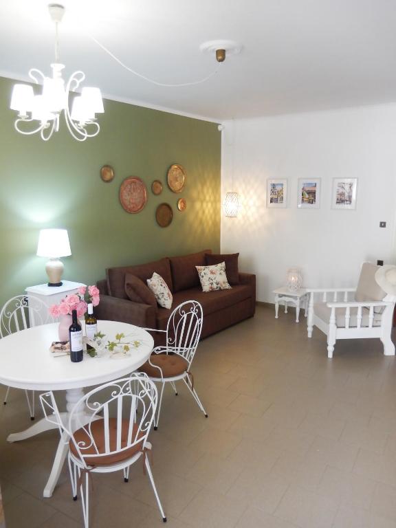 a living room with a couch and a table and chairs at Portico Cozy Home in Kariá