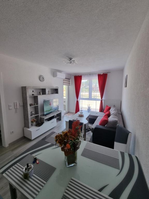 a living room with a couch and a table at Apartman Baban 1 in Kiseljak