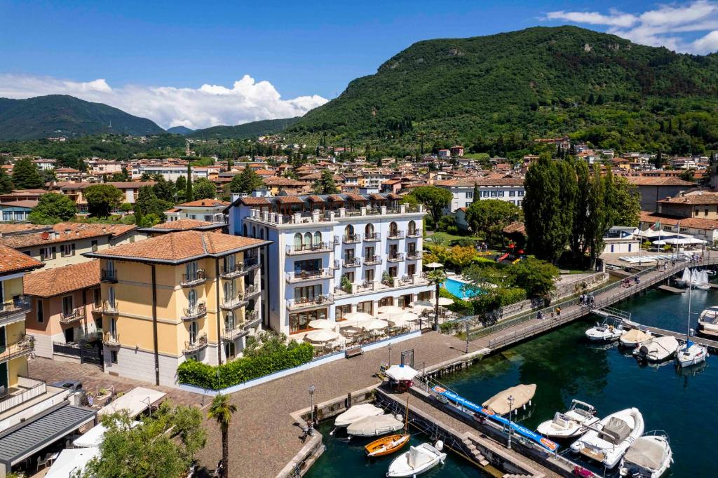 a city with a marina and boats in the water at Bellerive Lifestyle Hotel in Salò