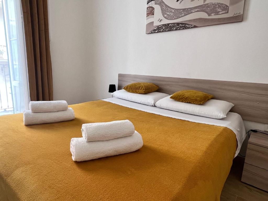 a bedroom with two beds with towels on them at GL Sun Palace in Bari