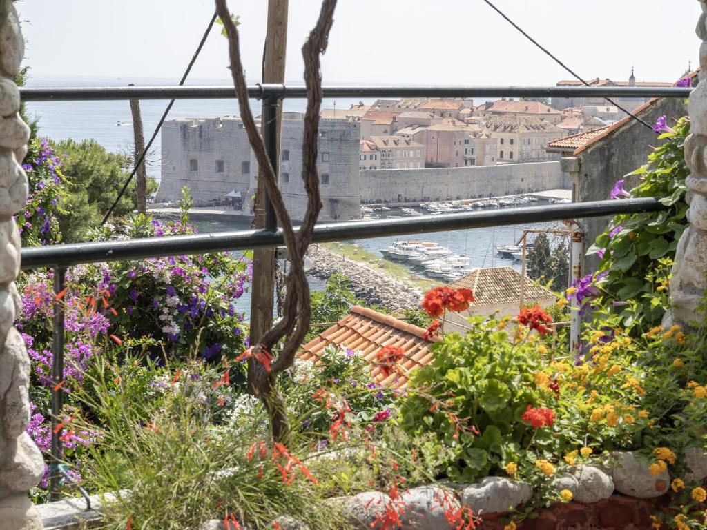 a view of the city from a flower garden at Garden Apartment Marina in Dubrovnik