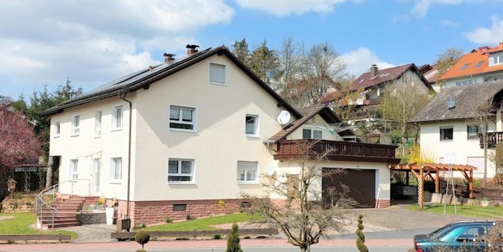 a large white house with a roof at Ferienwohnung Hanna in Hausen