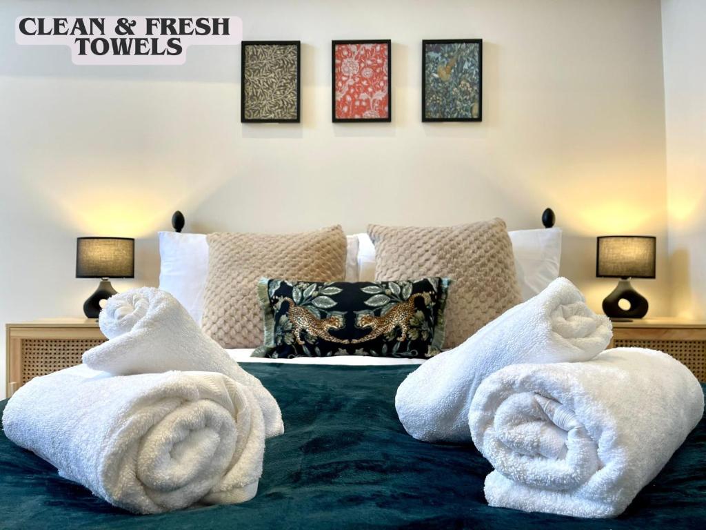 a bedroom with white towels on a bed at Brand New! Stunning, Stylish, Cosy Apartment in Centre of Saffron Walden in Saffron Walden