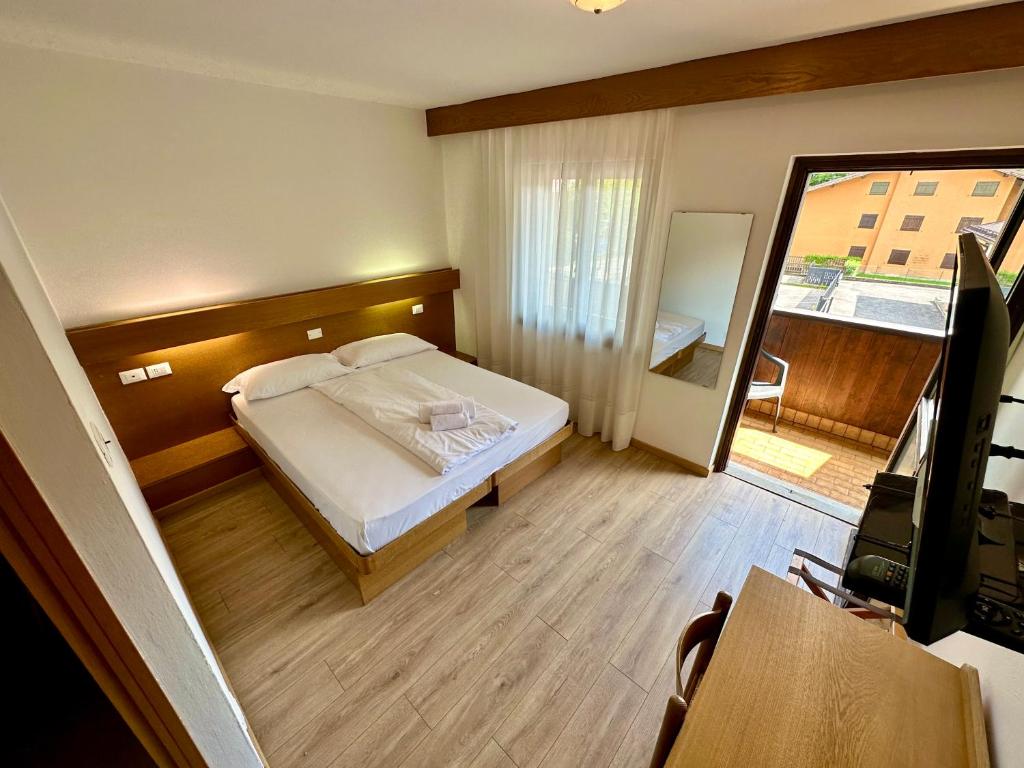 Postel nebo postele na pokoji v ubytování Hotel Ferrari