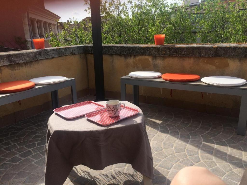 a table set up with plates and a cup on it at Duplex Cosy Vue Colline in Cavaillon