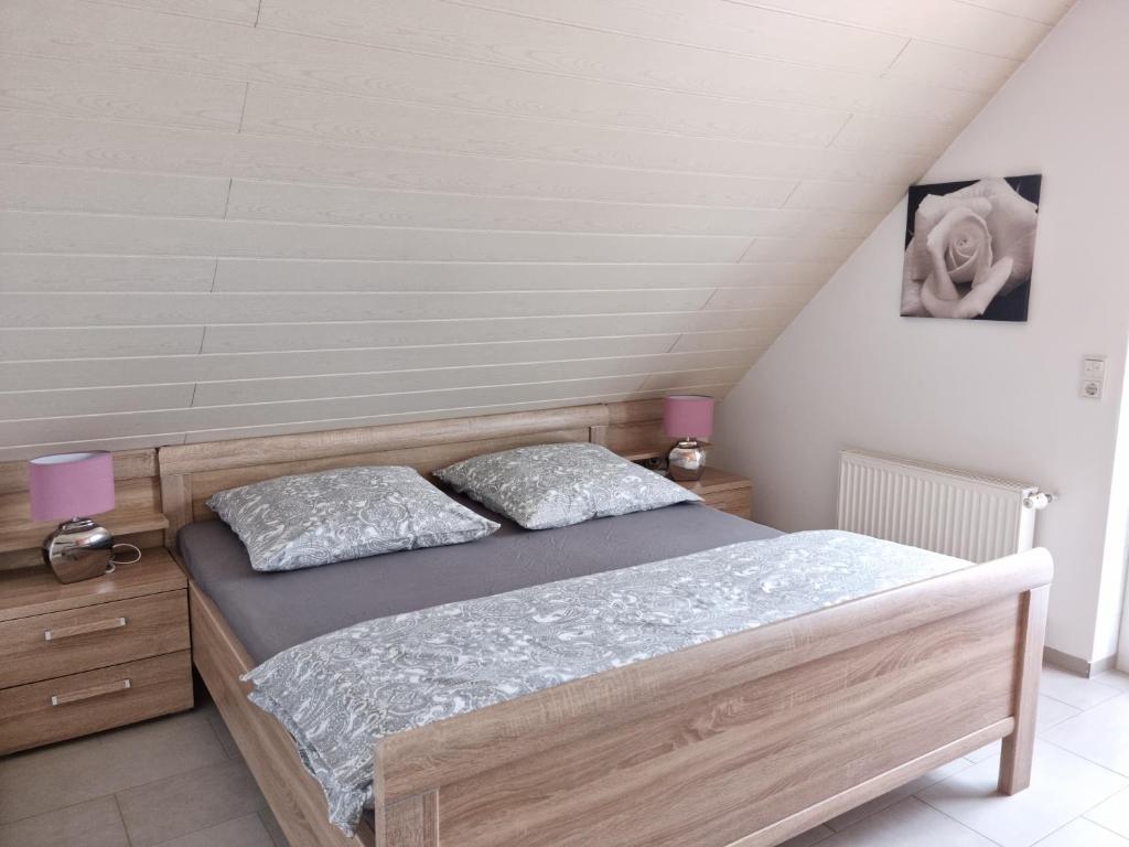 a bedroom with a bed with two pillows on it at Windlicht im 1 Stockwerk in Norddeich