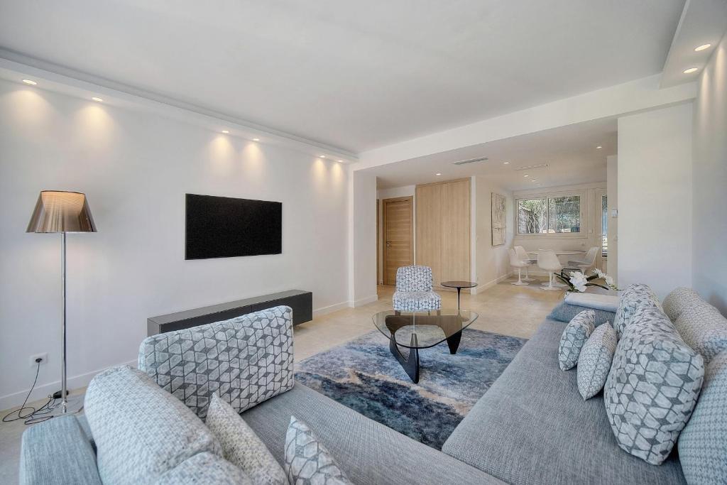 a living room with a couch and a table at Cannes Luxury Rental - Stunning renovated 2 bedroom apartment in Cannes