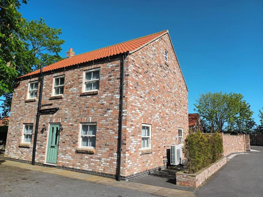 an old brick building with a green door at Secluded Quiet Country Escape 