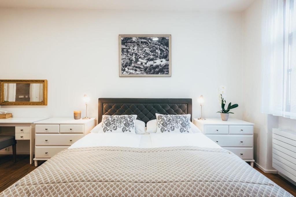 a bedroom with a large bed and a desk at Hotel Zlaty Andel in Český Krumlov