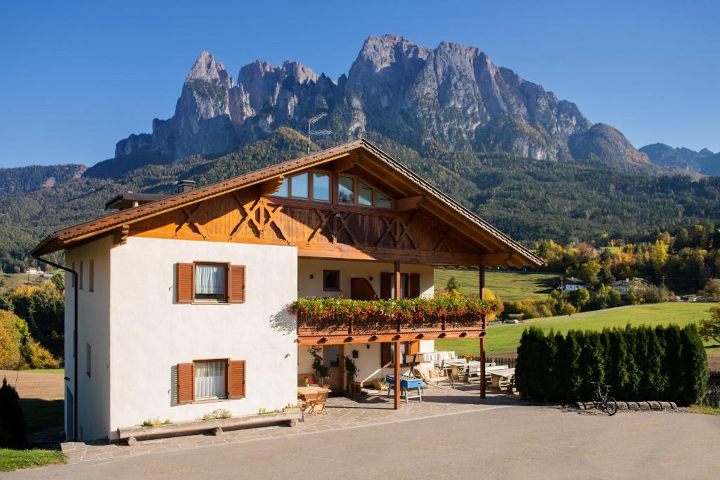 a house with mountains in the background at Mesnerhof my Paradise in Völs am Schlern