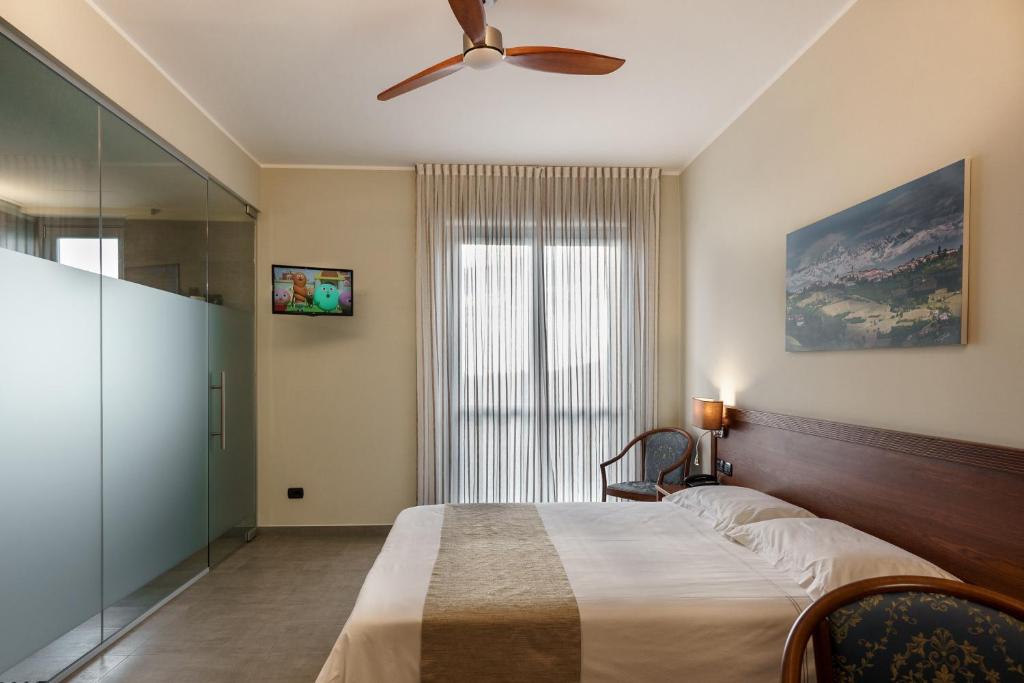 Postel nebo postele na pokoji v ubytování Hotel Il Grappolo D'Oro