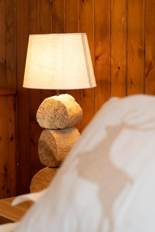 a lamp sitting on top of a stack of bread at Hotel Les Chamois in Verbier