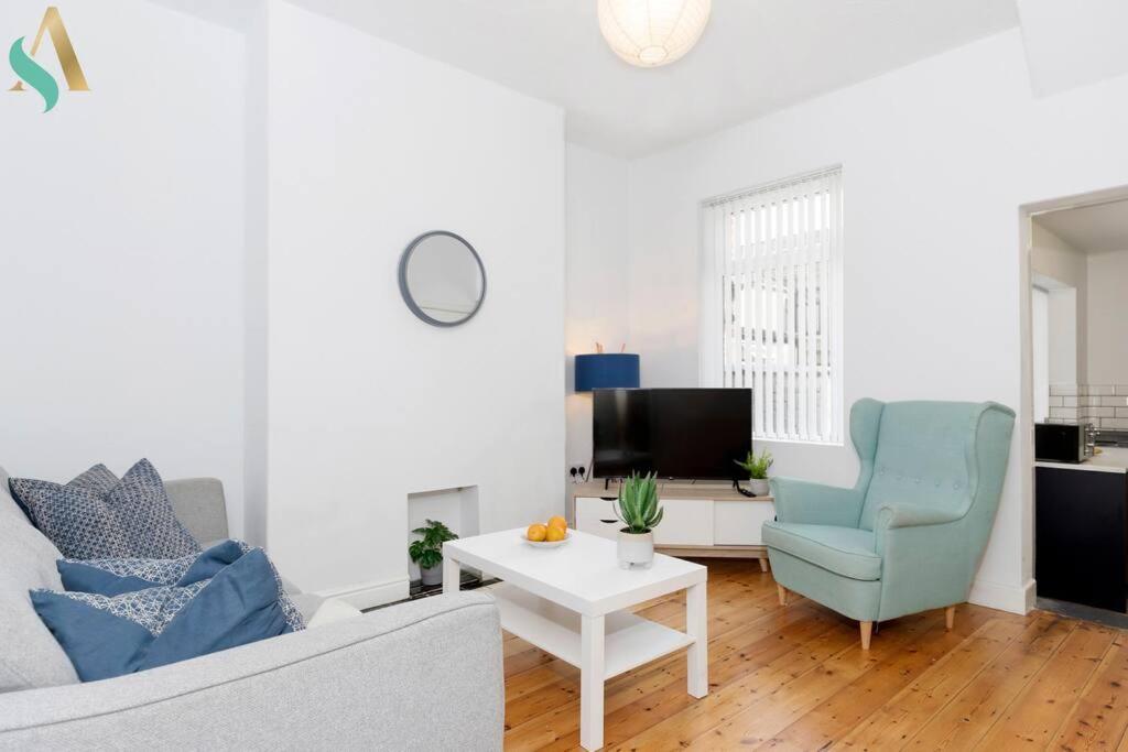 a living room with a couch and a chair and a table at Thornaby Road TSAC in Stockton-on-Tees