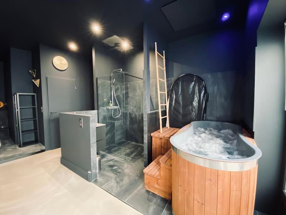 a bathroom with a large tub and a shower at La Shelby avec terrasse privée in Bordeaux