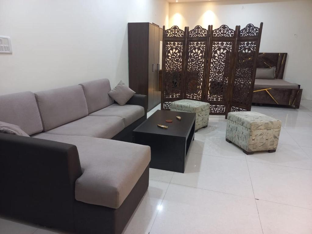 a living room with a couch and a table at Heritage home in Cannaught Place in New Delhi