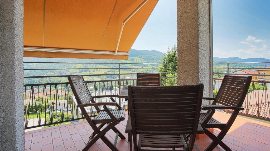 a balcony with chairs and a table with a view at Italianway - Via Pighini 75 in San Fedele Intelvi