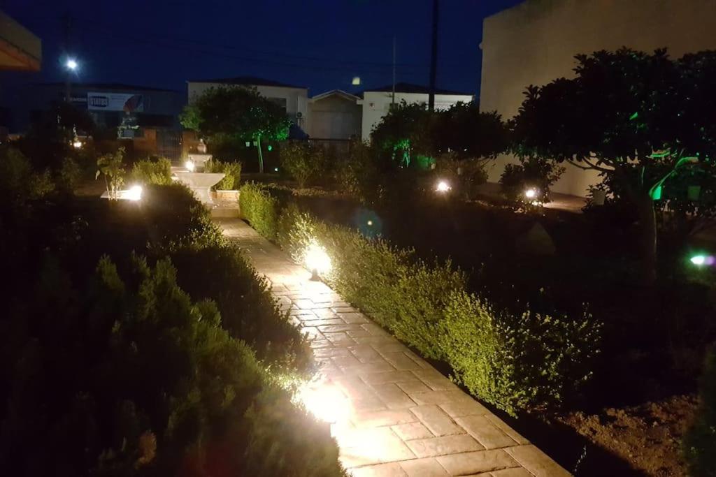 a walkway lit up at night with lights at Mastic House in Chios