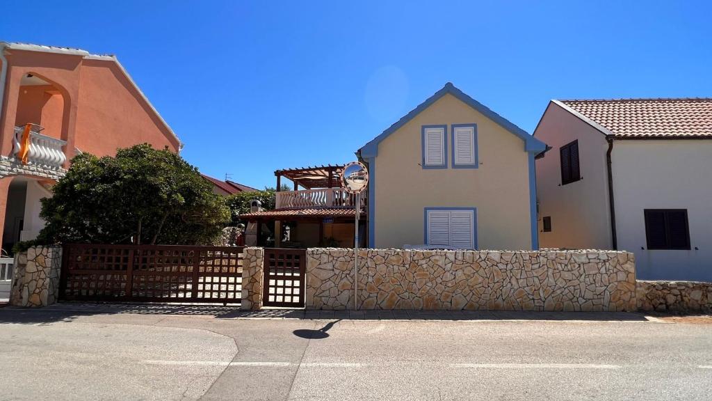a house with a fence in front of a house at Apartment 39 in Vir