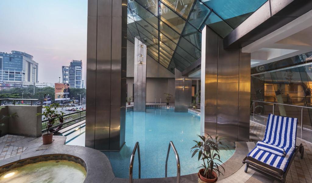 a swimming pool on top of a building at The Regenza By Tunga in Navi Mumbai