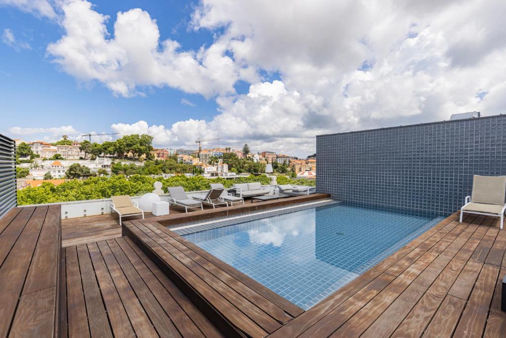 a swimming pool on the roof of a building at Liberdade Elegance W/Rooftop Pool by LovelyStay in Lisbon