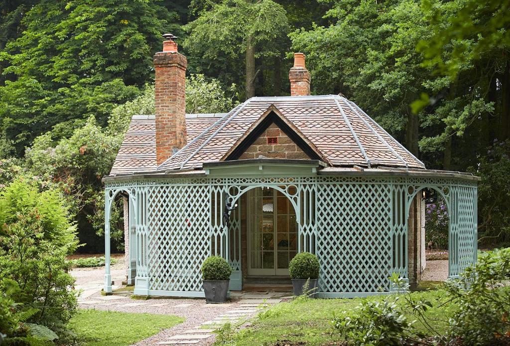 a gazebo in the middle of a garden at Pink Cottage in Shifnal