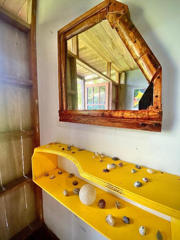 a bathroom with a yellow sink and a mirror at Utria hostel in El Valle