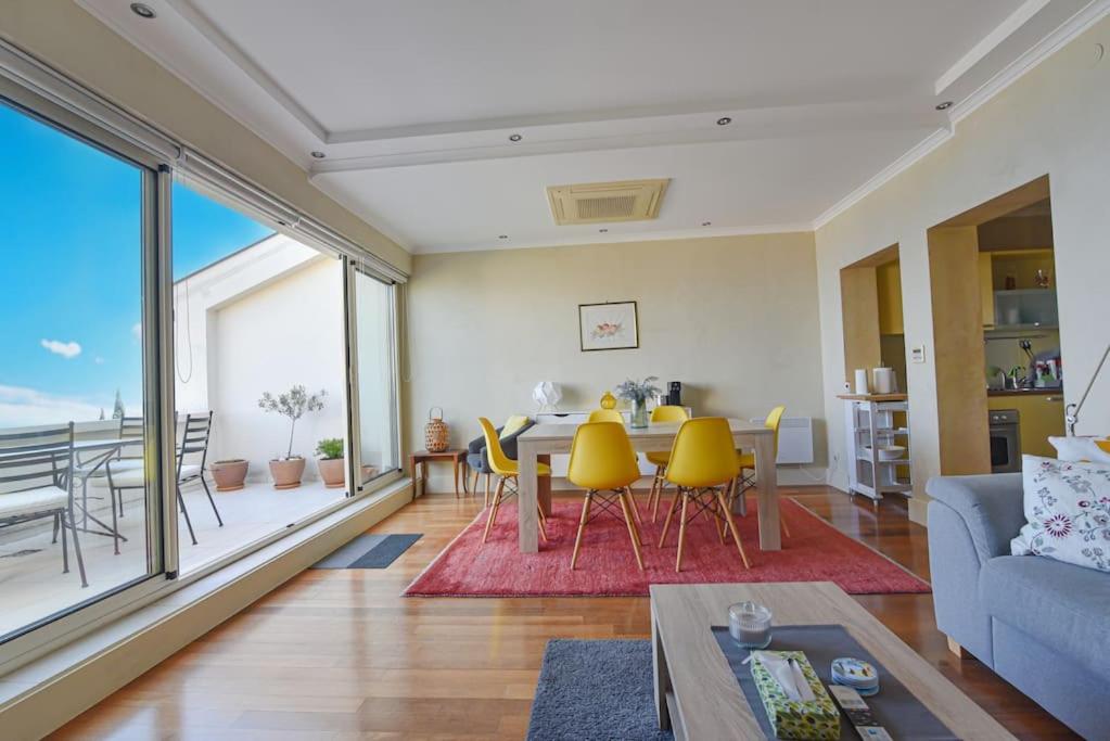 a living room with a table and yellow chairs at Villa Alba, Apartment Katja - with swimming pool in Ičići