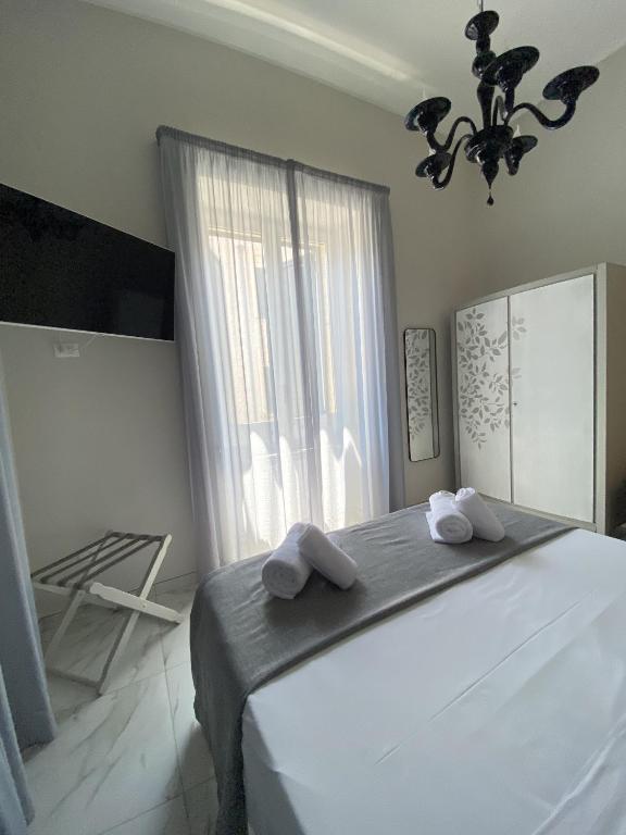 Łóżko lub łóżka w pokoju w obiekcie La Fitolacca B&B