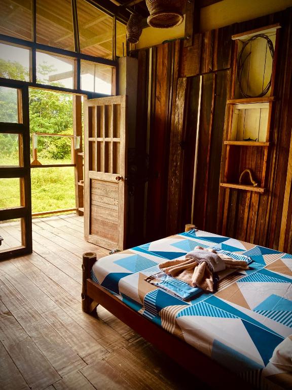 a bedroom with a bed in a room with a door at Utria hostel in El Valle