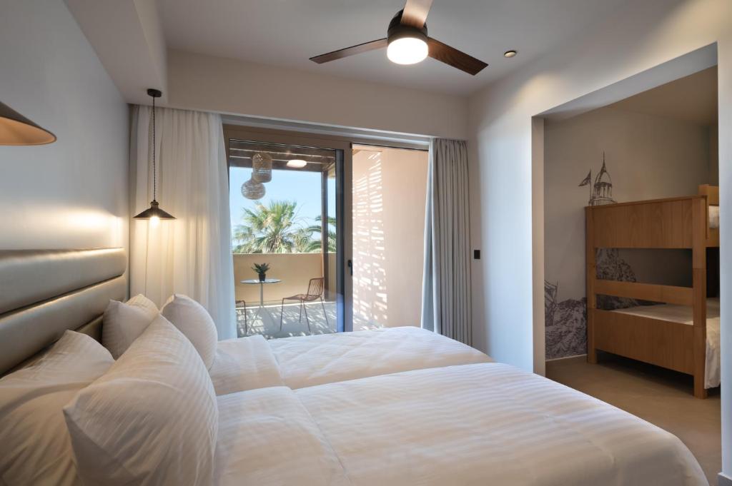 a bedroom with a large white bed and a window at Prasonisi Light House Boutique Hotel in Prasonisi