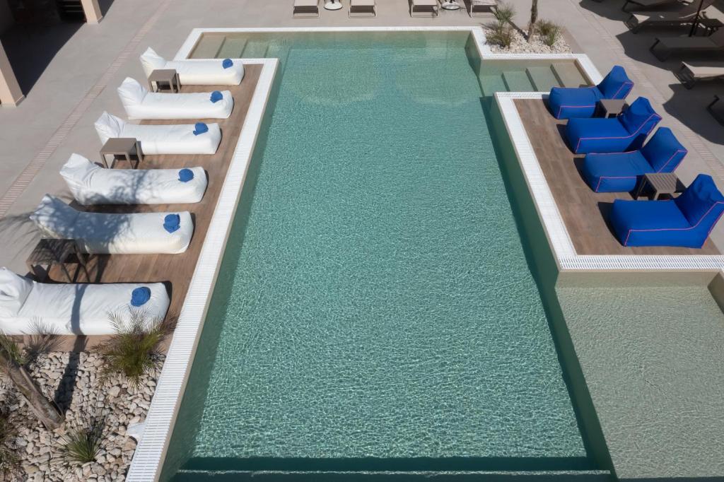 a swimming pool with lounge chairs and a resort at Prasonisi Light House Boutique Hotel in Prasonisi