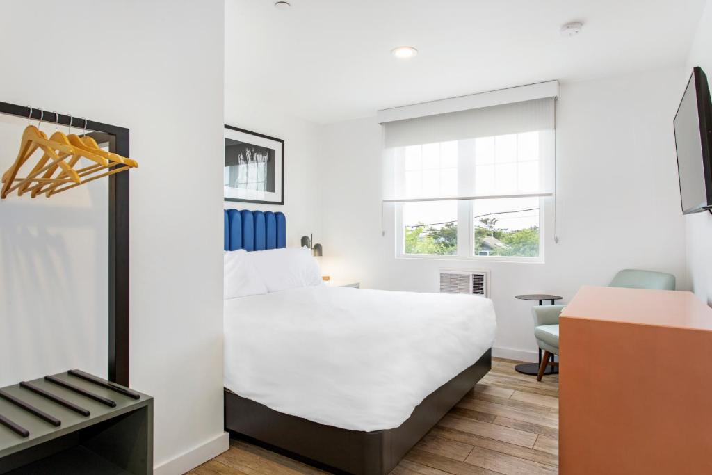 a hotel room with a bed and a desk at Grove Hotel in Cherry Grove