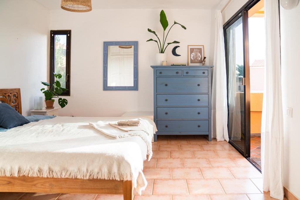 a bedroom with a blue dresser and a bed at Casa Harmonia in La Pared