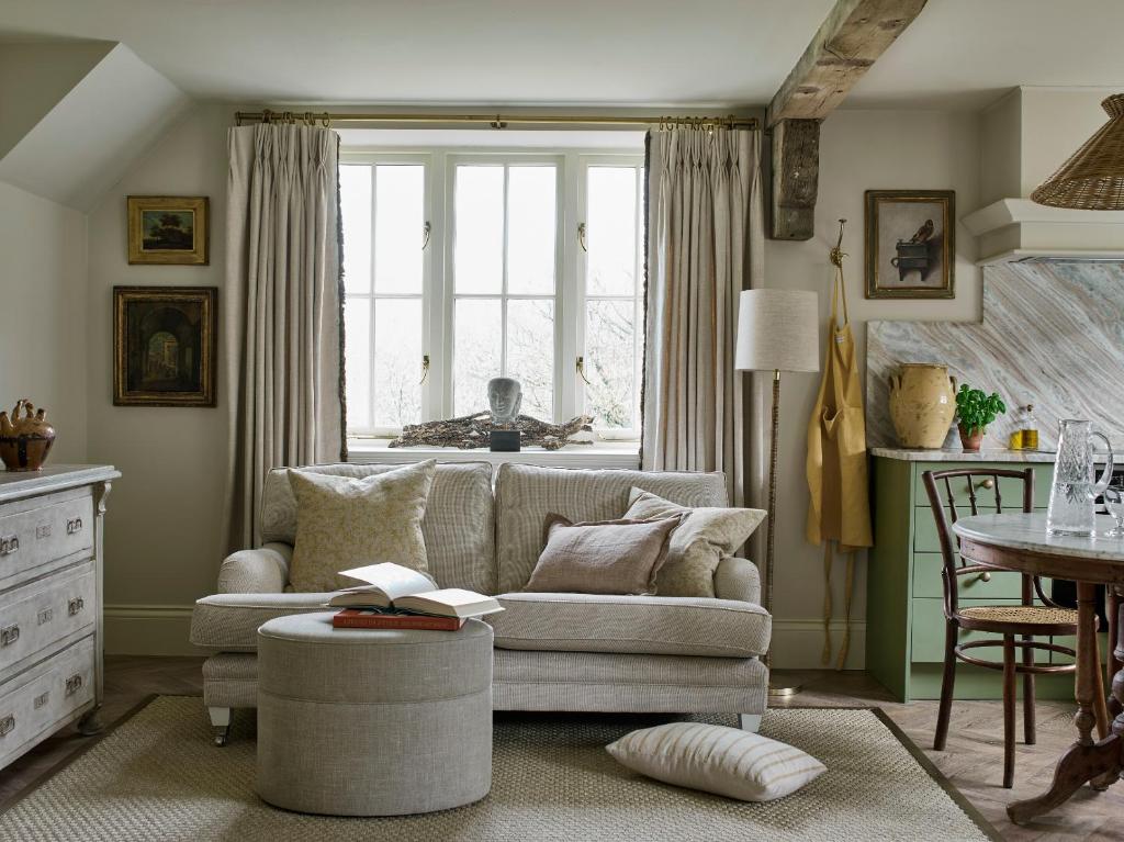 a living room with a couch and a window at Plum Henley in Henley