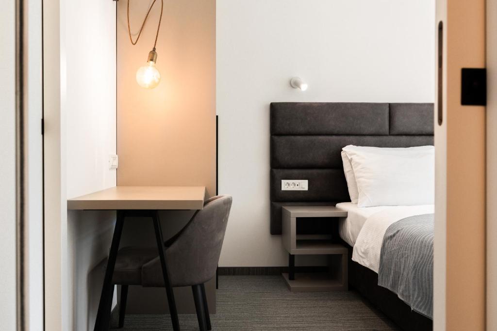 Posteľ alebo postele v izbe v ubytovaní Hotel Alkar