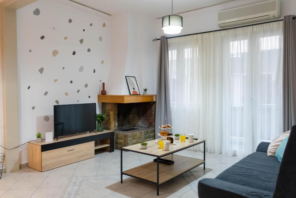 a living room with a couch and a tv at Cozy Central Home Heraklion in Heraklio Town