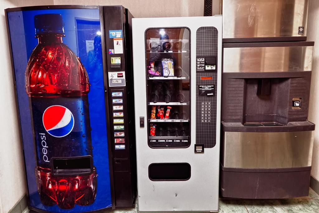 a cocacola bottle next to a pepsi machine at Arch Canyon Inn in Blanding